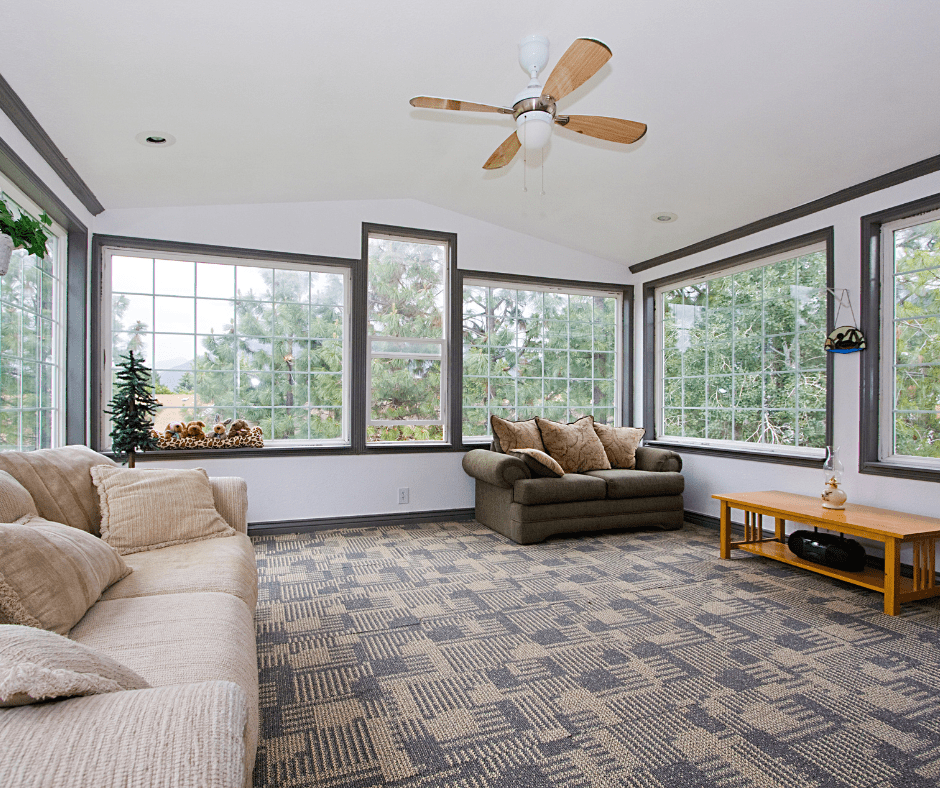 sunroom with lots of windows, a ceiling fan, and modern patio furniture
