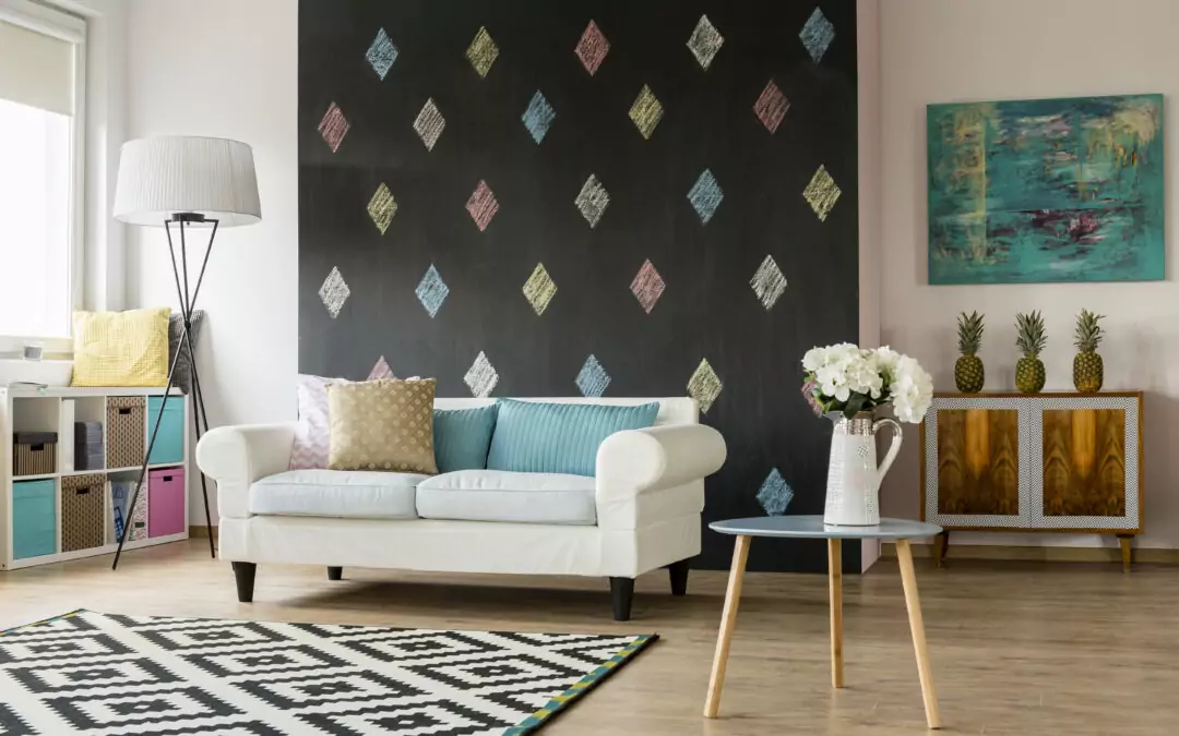 white couch in front of black chalkboard paint walls with colorful diamond pattern